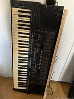 Top-down view of Yamaha PSR-410 keyboard showing full length of keys and control panel, with ruler indicating size