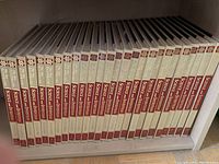 Photo showing all 26 volumes of the Science and Invention Encyclopedia arranged vertically on a shelf, spines visible and clearly numbered.