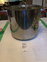 Front view of large stainless steel Paderno stock pot with lid and visible scratches.