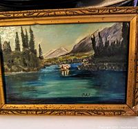 Frontal view of framed oil painting showing landscape and signature