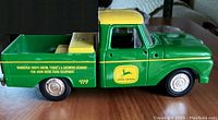 Side view of the green and yellow vintage John Deere pickup truck model showing branding and detailing