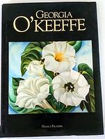 Georgia O'Keeffe art book with black dust jacket featuring a white flower painting on the cover by Nancy Frazier.