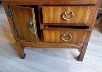 Open door view revealing storage space inside the cabinet, and detail of drawer dovetail joinery and original metal hardware.