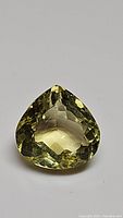 Front view of pear cut lemon citrine gemstone showing color and facet details