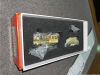 Foam tray with locomotive and tender shells inside red and white original box