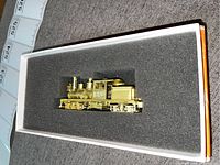 Brass model locomotive in foam-lined original orange and white box
