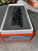 Top-down view of locomotive and tender in foam-lined original box