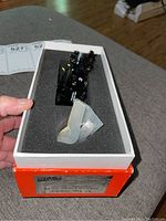 Locomotive and accessory bag in foam-lined orange and white box