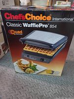 Boxed Chef's Choice Classic WafflePro 854 waffle maker showing product image and branding.