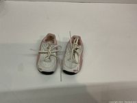 Front view of infant Puma running shoes, showing wear and design details