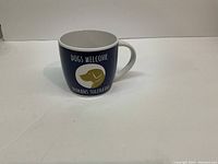 Photo of the dog-themed ceramic coffee mug showing text and dog illustration