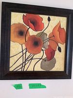 Framed square floral print artwork as seen from a full view showing frame and flower design