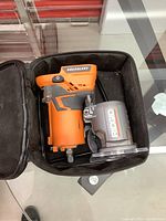 Front view of router in soft zippered case showing brushless label and fixed base