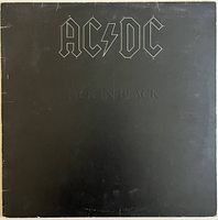 Front cover of AC/DC Back in Black vinyl LP, black with silver embossed logo and text, shows some edge wear.