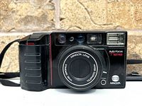 Front view of Minolta AF-Tele camera showing lens, flash, and grip