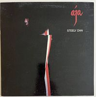 Front cover of the Steely Dan Aja vinyl LP showing stylized artwork and album title.