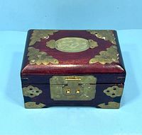 Front top angled view of the dark wood box showing brass fittings and jade inlay