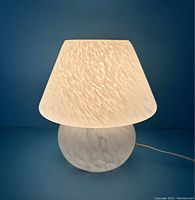 Lamp illuminated against blue background