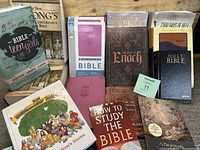 Full lot of multiple books centered around Bibles and Bible study, some hardcovers, some paperbacks.