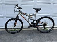 Side view of Mongoose CR-75 mountain bike showing full suspension, frame, tires, saddle