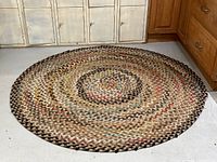 Top-down view of the round braided rug showing its full circular shape and color pattern