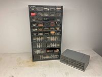 Photo of two hardware bins, one tall with many small drawers, one smaller with six drawers, both gray.
