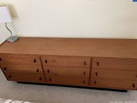 Front view of dresser showing all six drawers and plinth base