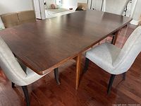 Full side-angle view of the table with one leaf inserted