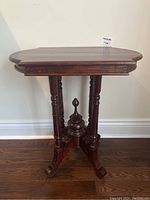 Full view of antique mahogany side table showing octagonal top and pedestal base with four turned legs.
