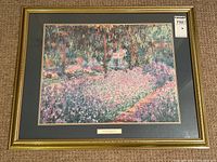 Full view of framed Monet print titled "The Artist's Garden at Giverny" with gold frame and dark matting.