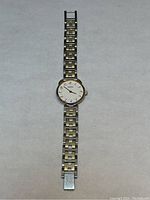 Full front view of entire watch laid flat showing case, dial and complete bracelet