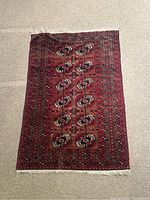 Full view of the vintage Persian-style rug showing the geometric and floral pattern in red and blue hues.