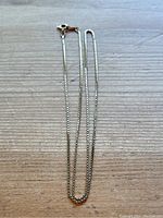 Full view of gold box chain necklace with spring ring clasp