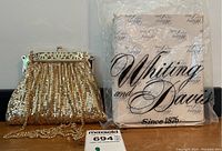 Gold mesh evening purse displayed next to original Whiting & Davis branded box with decorative script, highlighting condition and packaging.