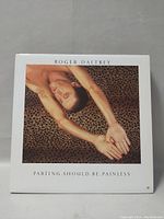 Full cover of Roger Daltrey's album Parting Should Be Painless showing a photo of Roger with outstretched arms on leopard print background