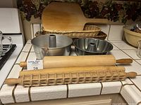 Overview of baking items including wooden rolling pins, baking pans, and baskets.