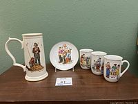 Full set of 5 Norman Rockwell collector porcelain items visible including stein, plate, and three mugs with various Rockwell artwork.