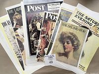 Color photographic prints of vintage magazine covers including The Delineator and The Saturday Evening Post on thick paper.