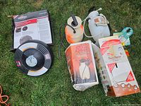 Photo showing all sprayers and the Briggs & Stratton surface cleaner box arranged on grass