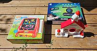 Photo of Snoopy snow cone maker, Lite Brite set, and Hover Blast Nerf style floating target in boxes to show lot contents.