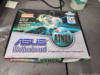 Box of Asus A7N8X motherboard showing front packaging with model name and branding.