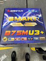 Front of box showing Biostar branding, model B75MU3+, product features.
