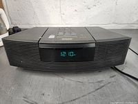 Front view of the Bose Wave Radio/CD Player showing digital time display and front speaker grills.