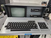 Front view of Kaypro 4 showing CRT display, dual floppy drives and attached keyboard