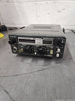 Front view of Kenwood 2m FM transceiver with control knobs, switches, microphone connector, and brand label visible.