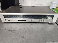 Front view of the Sansui Classique T-700 tuner showing the entire front panel with controls and frequency display.