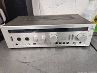 Front angle view of Sansui Classique A-700 amplifier showing metal casing, dials, switches, and power meter.