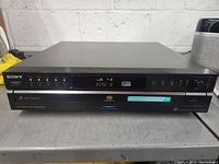 Front view of Sony 5 disc changer audio component showing display and control buttons