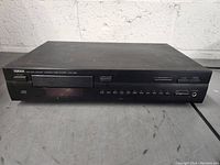 Front view of the Yamaha Natural Sound CD player showing the whole unit on a concrete surface.