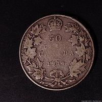 Reverse side of the 1914 Canadian 50 cent coin showing '50 CENTS CANADA 1914' surrounded by maple leaves and a crown.